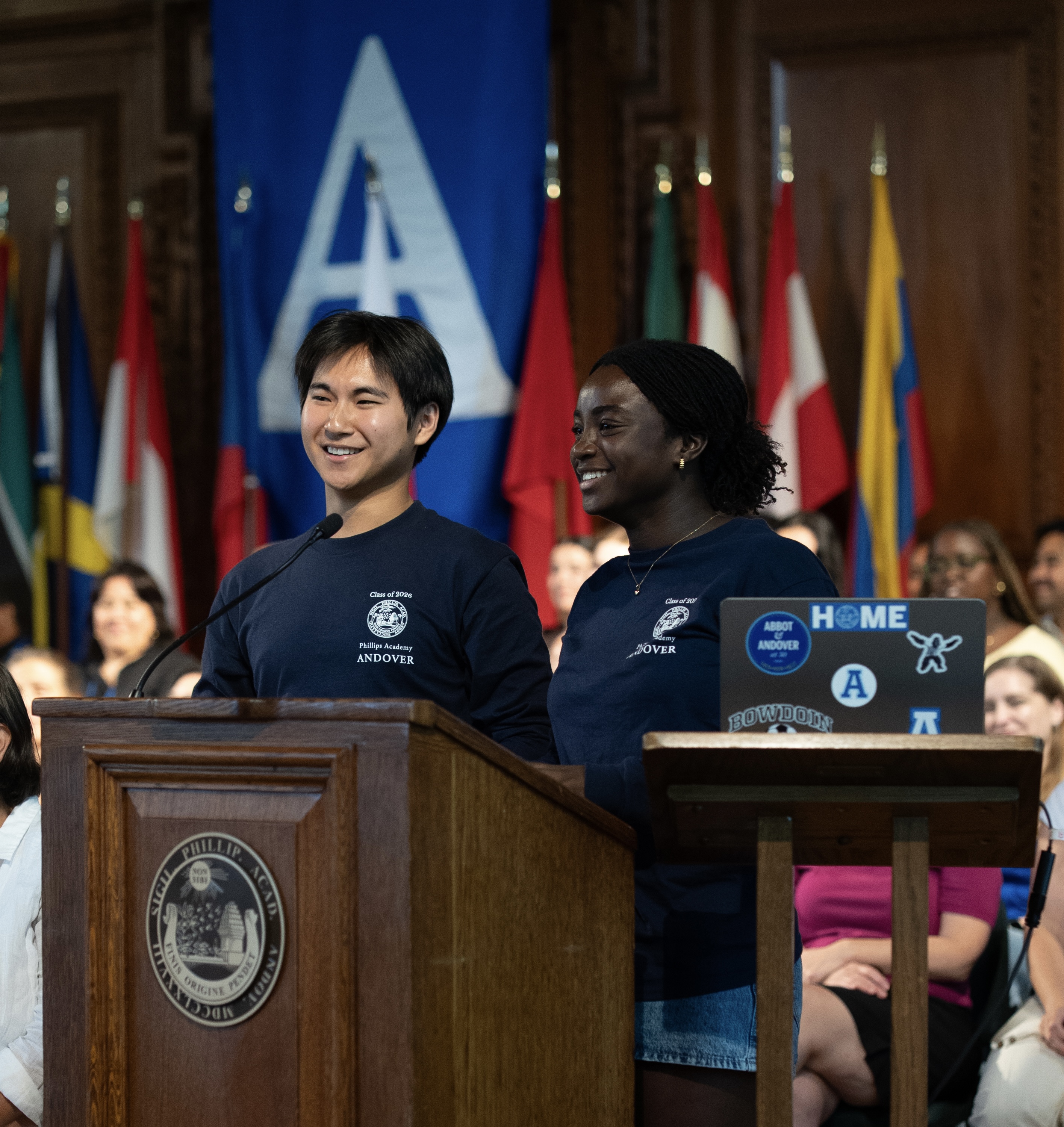A photo of Philip and Gracie Aziabor speaking at PA's first All-School Meeting.