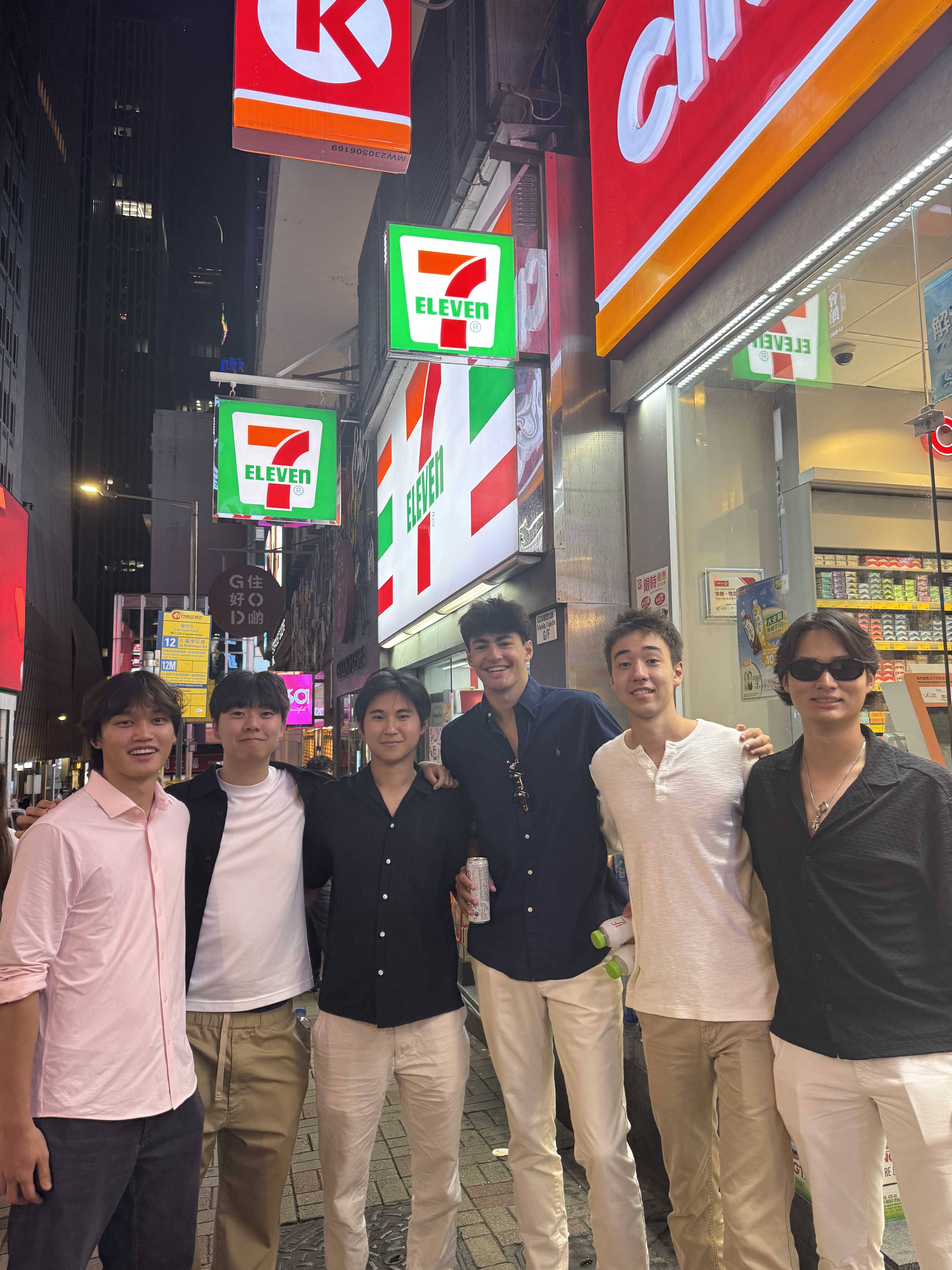 A photo of Philip and his 5 friends from Eaglebrook School during a reunion, standing together outside a 7/11 in Hong Kong.