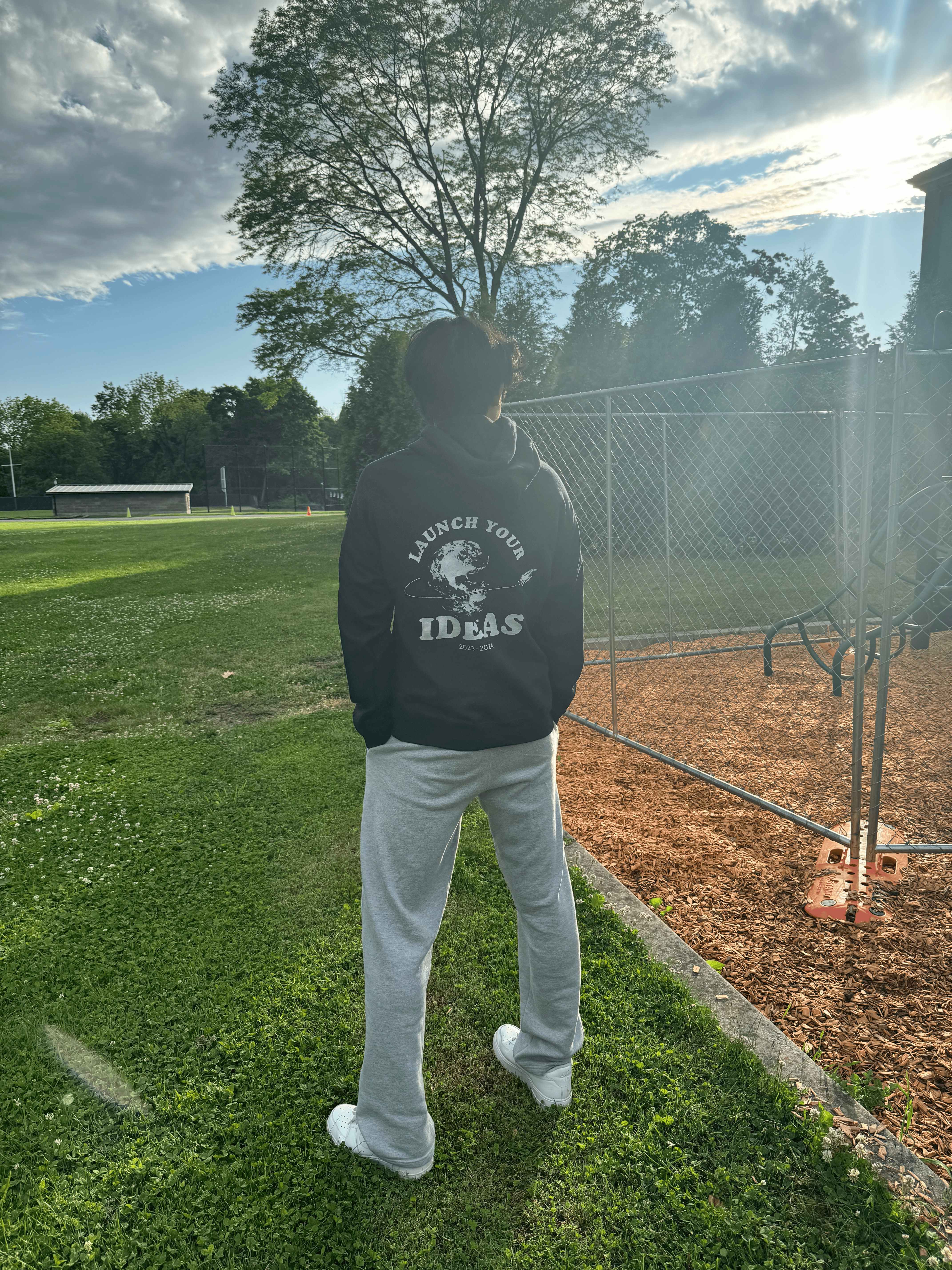 A photo of Corey Shen wearing the hoodie design for Launchpad.