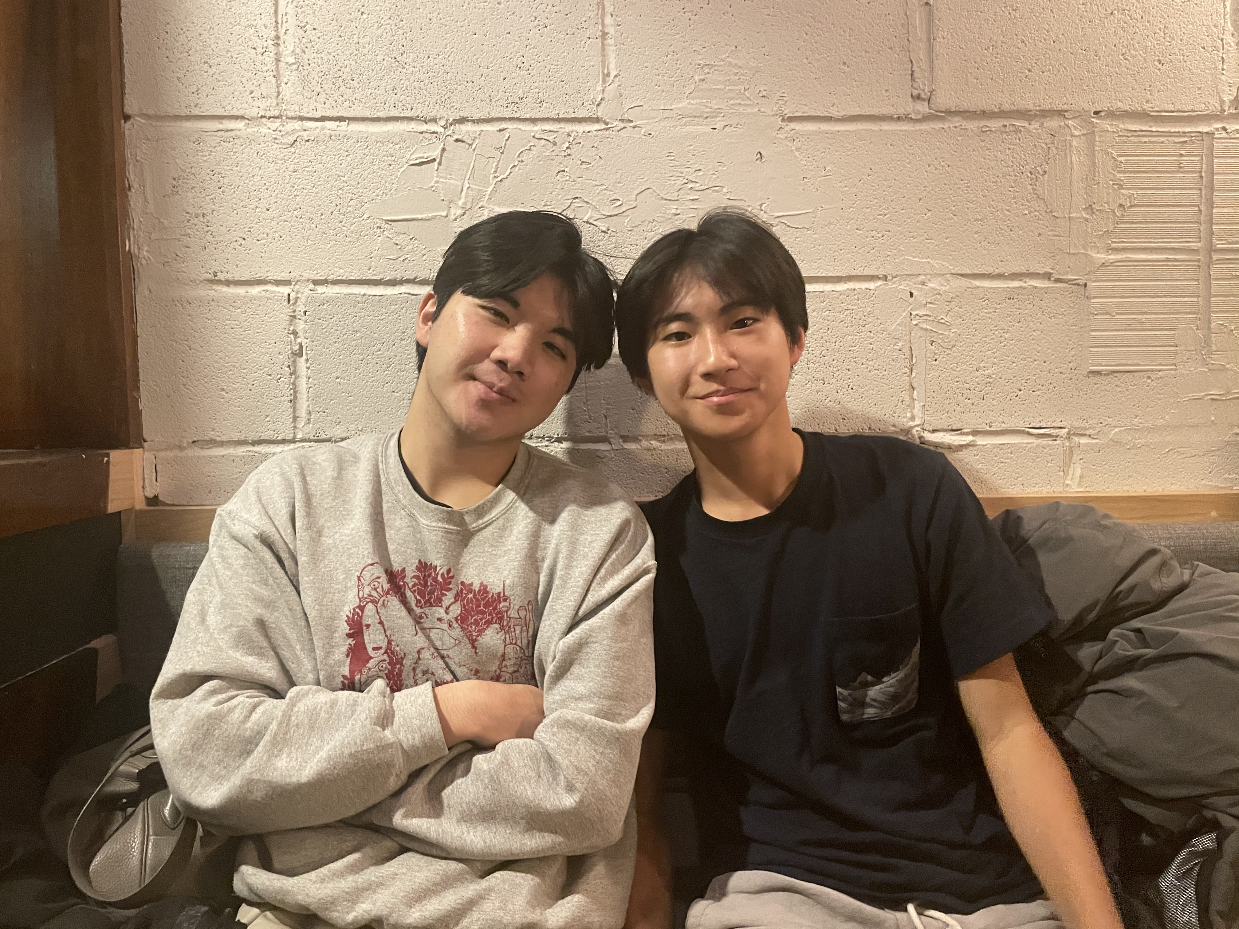 A photo of Philip and his older brother Sean sitting side-by-side smiling.