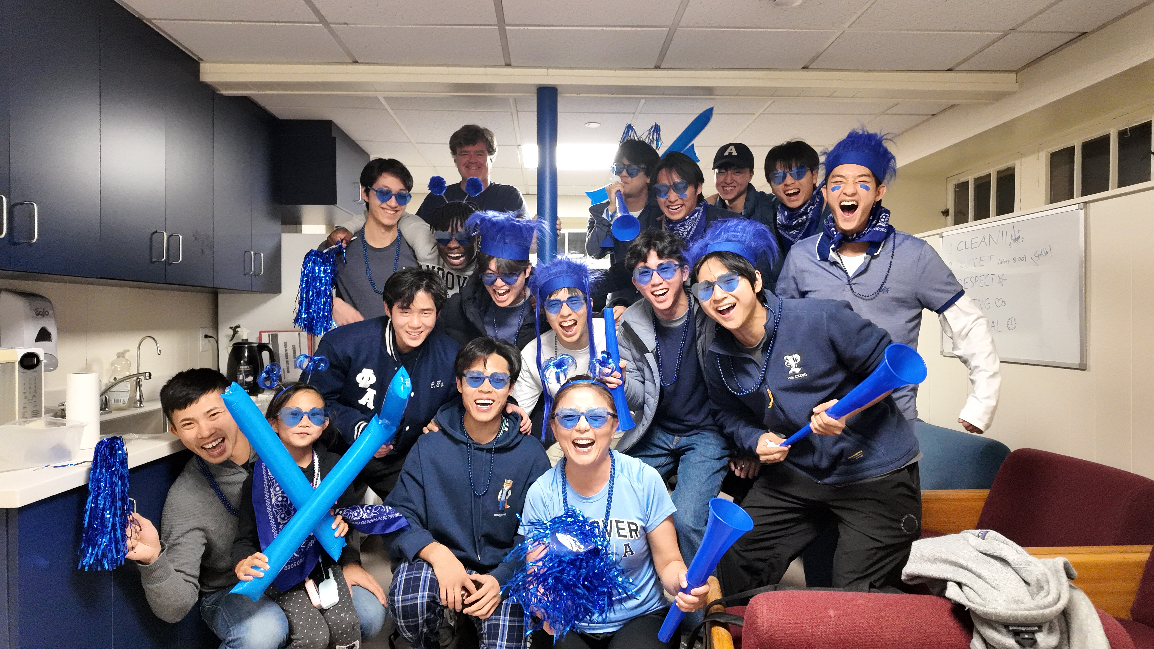 A photo of Philip and the rest of the Andover Cottage dorm in full blue spirit outfits before Andover / Exeter day.